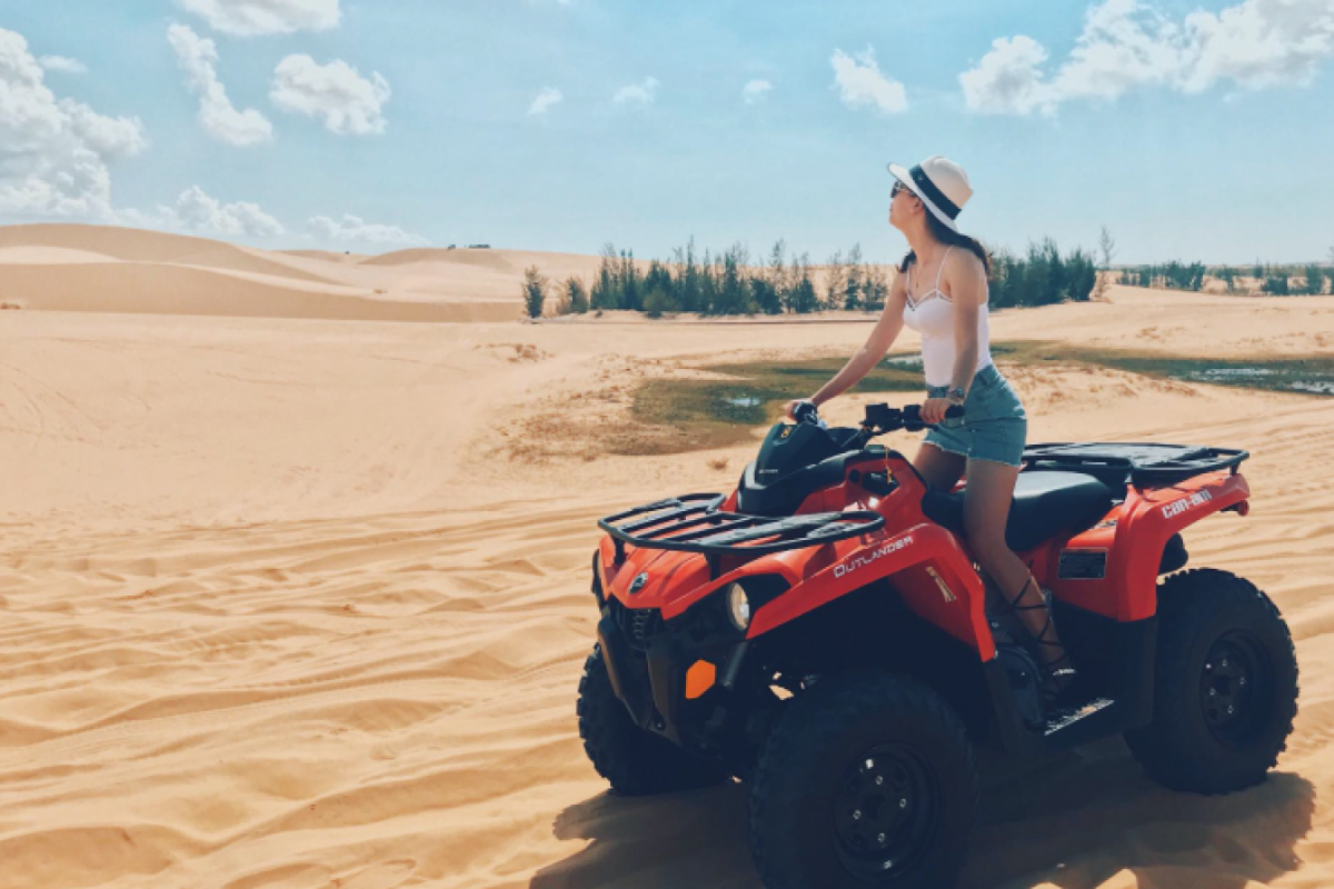 Tourists riding ATVs across Mui Ne Red Sand Dunes during a sunset tour